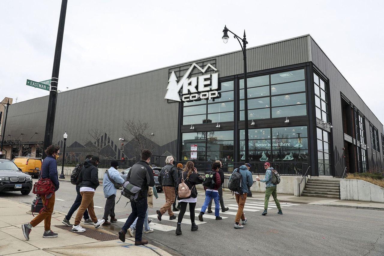 Employees at REI march to a Chicago store to announce their intention to file for a union election on March 31.