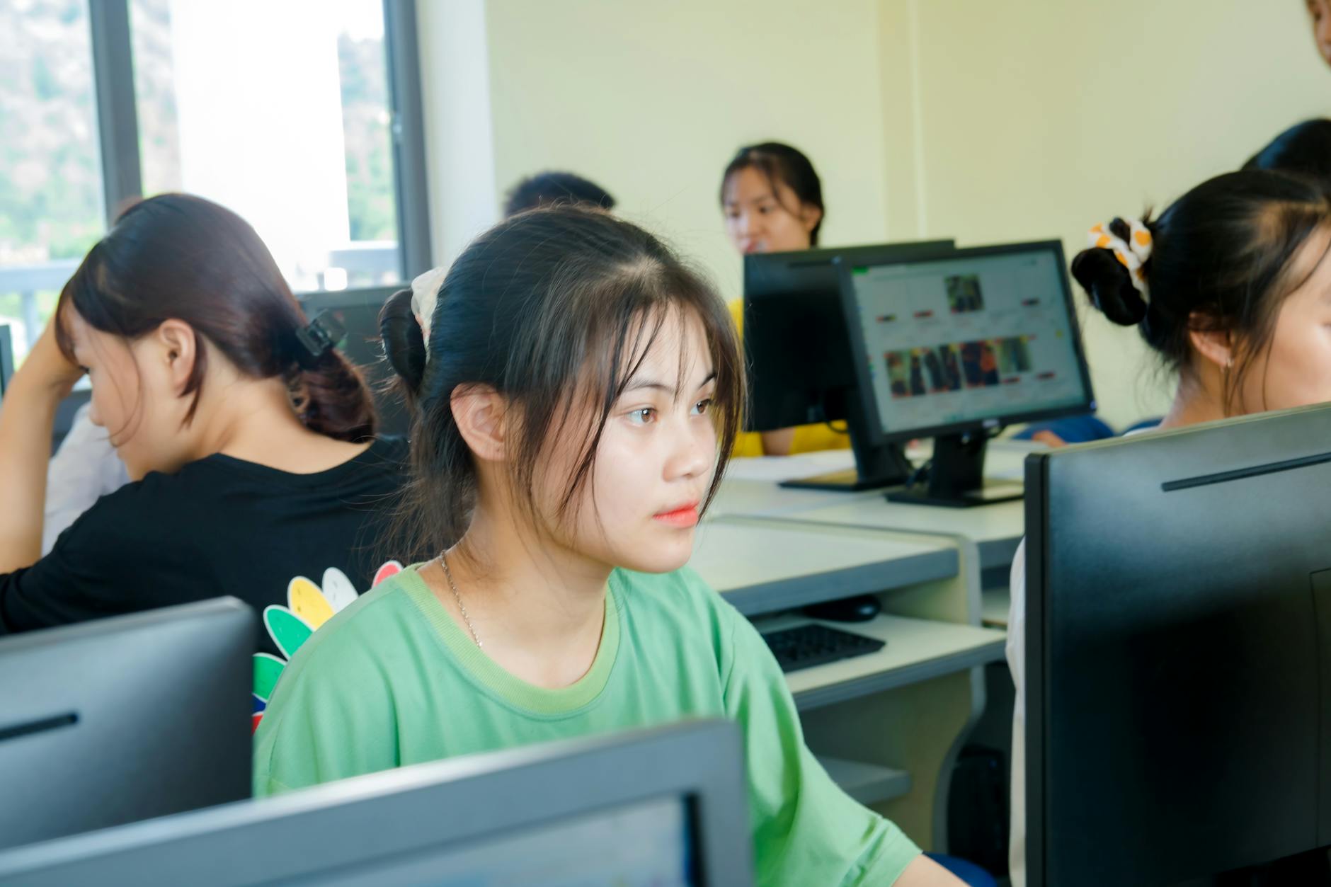 Students using computers in a modern classroom with digital learning technology
