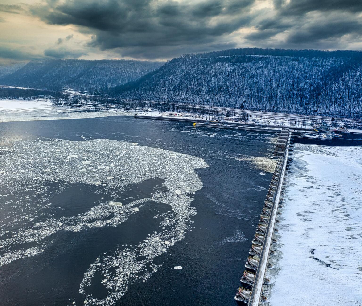 Aerial view of water reservoir and dam infrastructure showing institutional water asset investment