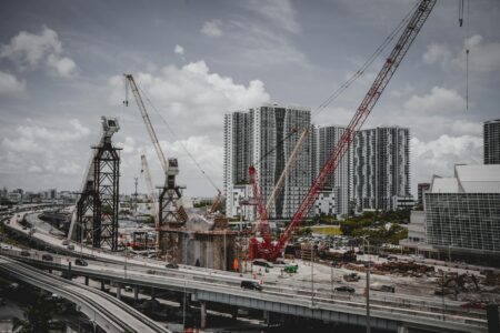 Construction workers repairing urban infrastructure with heavy machinery and road work equipment