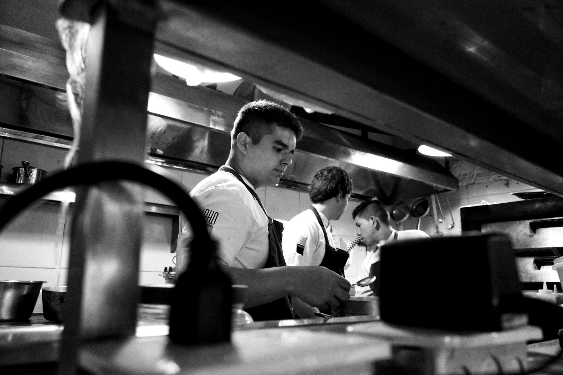Restaurant kitchen workers preparing food during busy service period