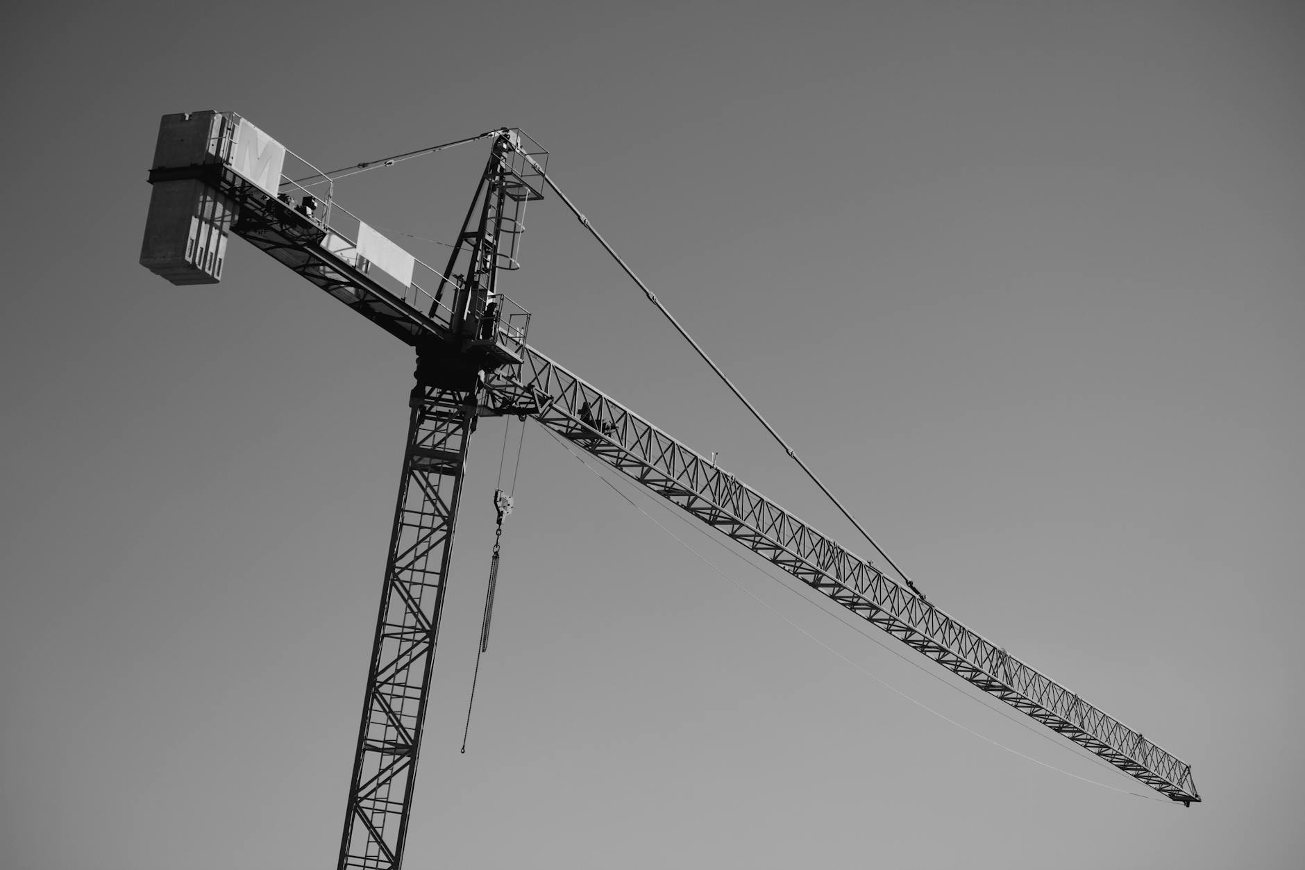 Construction crane against blue sky representing infrastructure development and investment