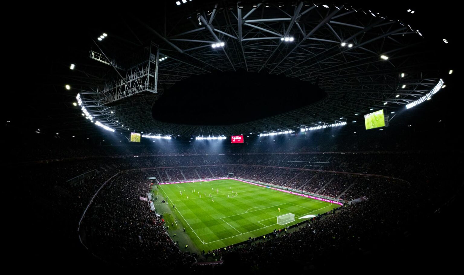 Streaming Services Pivot to Live Sports as Subscriber Growth Stalls Illuminated stadium lights at sports venue during evening event