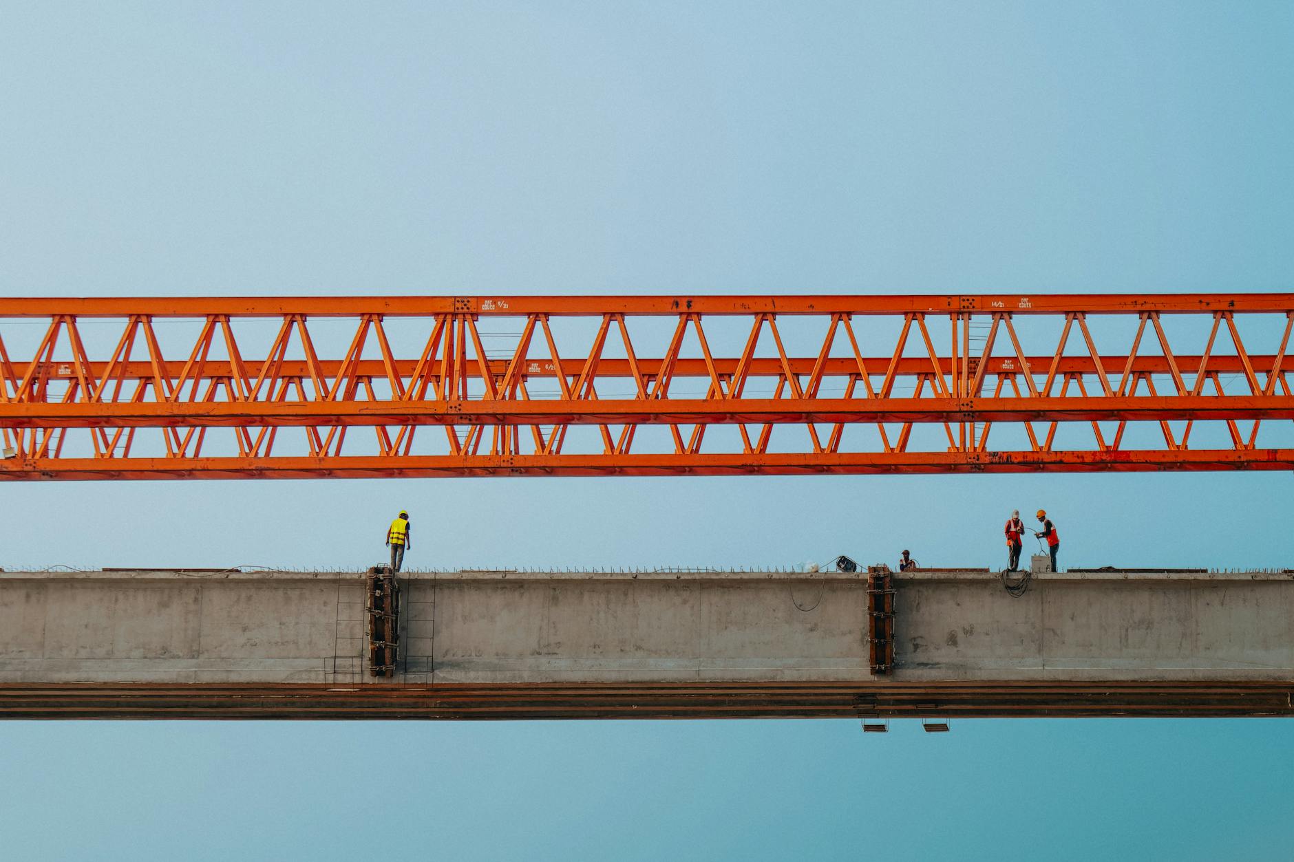 Construction work on aging infrastructure bridge with heavy machinery and repair equipment