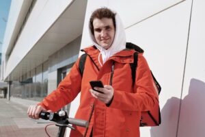 Food Delivery Apps Face Profitability Crisis as Consumer Spending Shifts Person using smartphone food delivery app interface on mobile screen