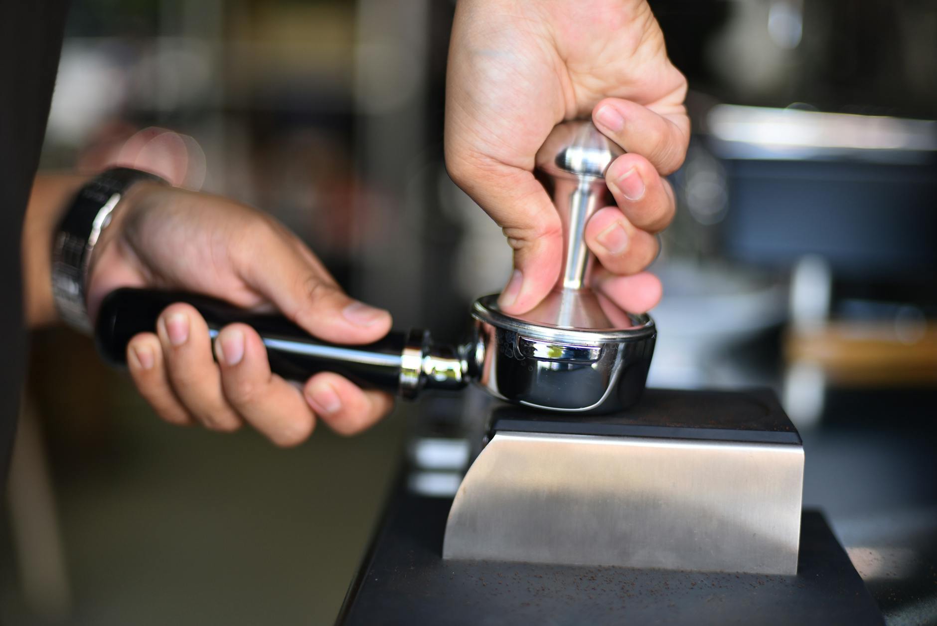 Professional barista preparing specialty coffee drink behind counter