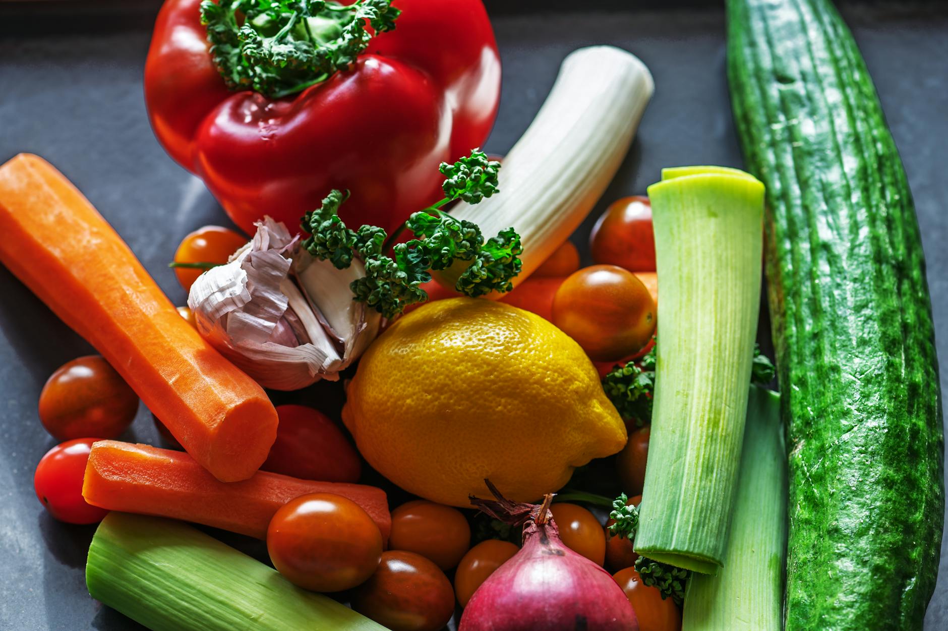Fresh vegetables and plant-based ingredients arranged on table