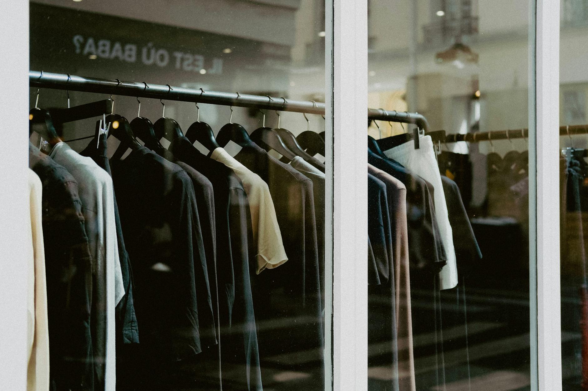 Organized clothing rack displaying sustainable fashion garments in retail store