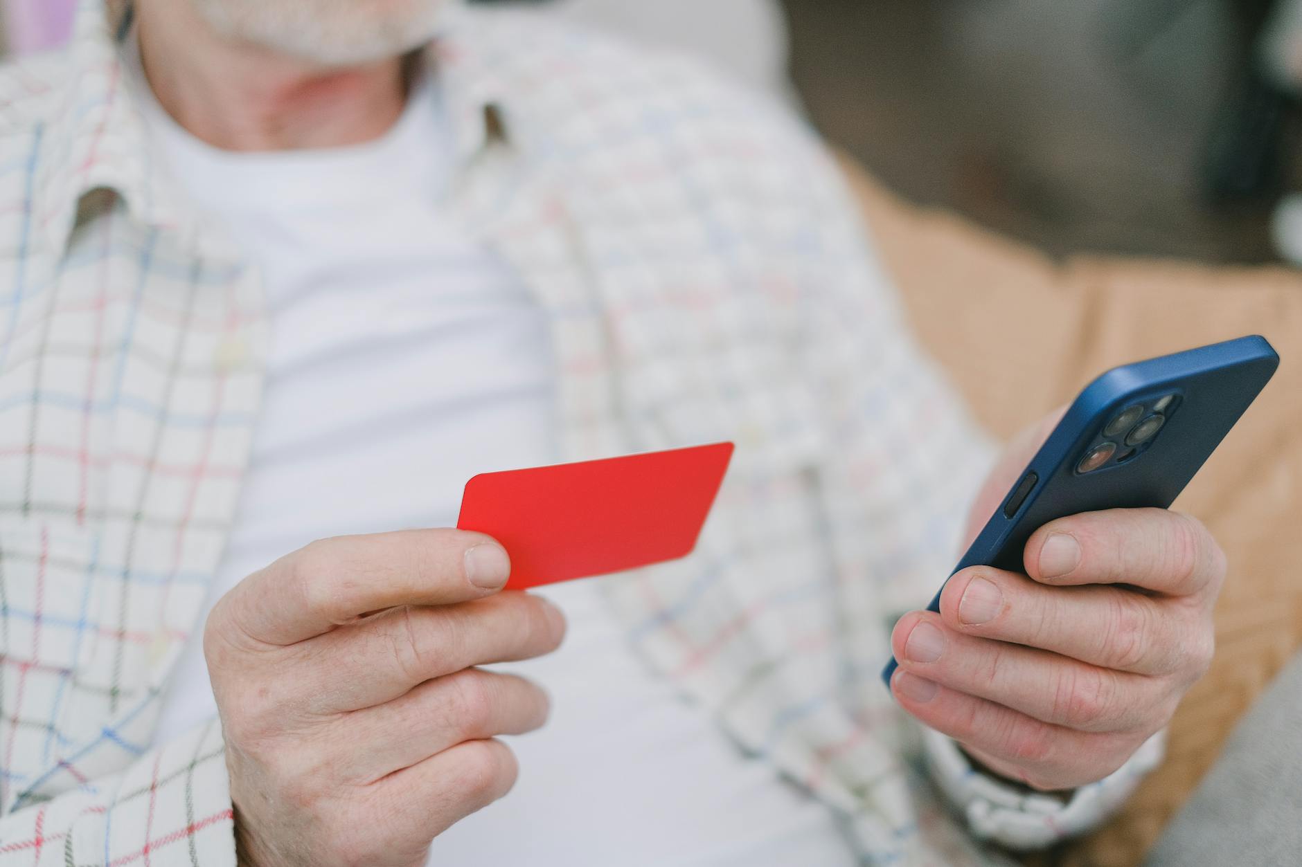 Person using smartphone for mobile payment at checkout