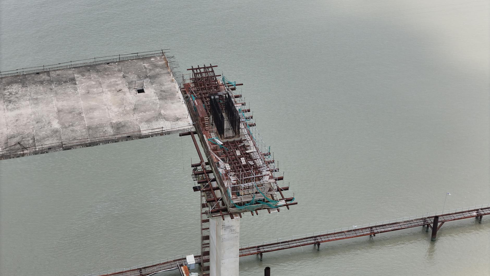 Construction workers repairing aging bridge infrastructure representing municipal investment needs
