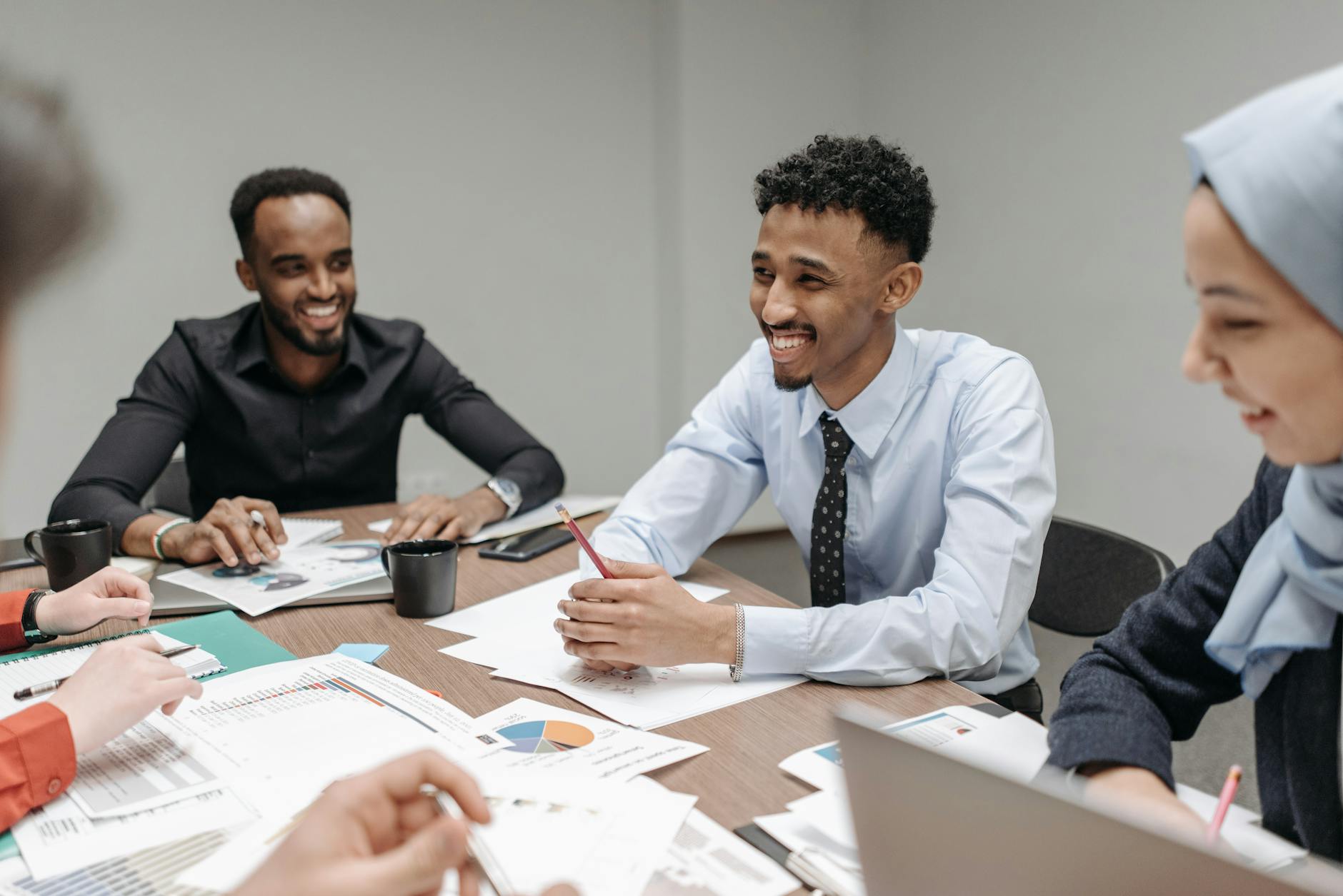 Group of diverse investors discussing investment strategies at table