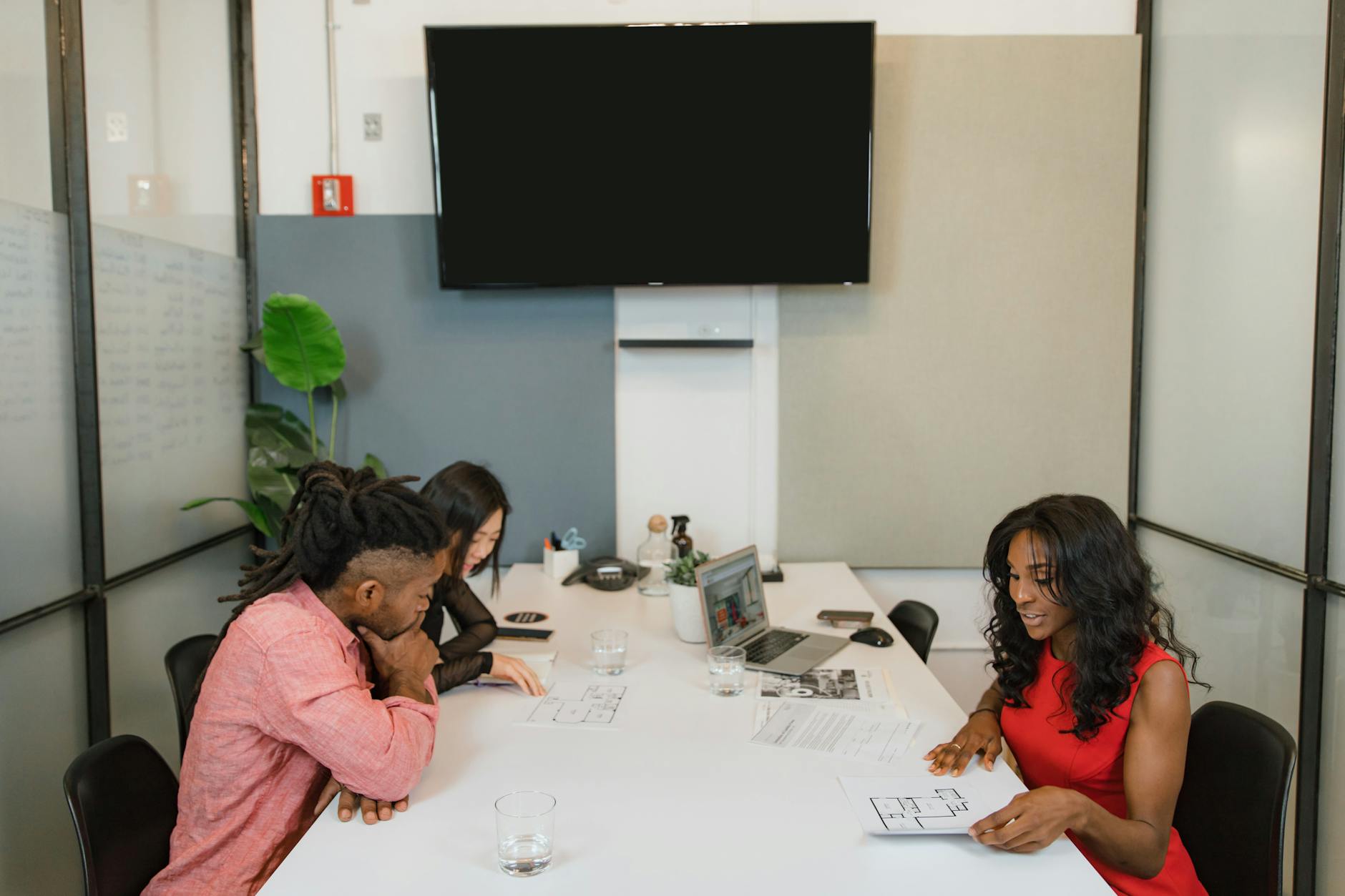 City officials and planners reviewing infrastructure development plans in modern conference room