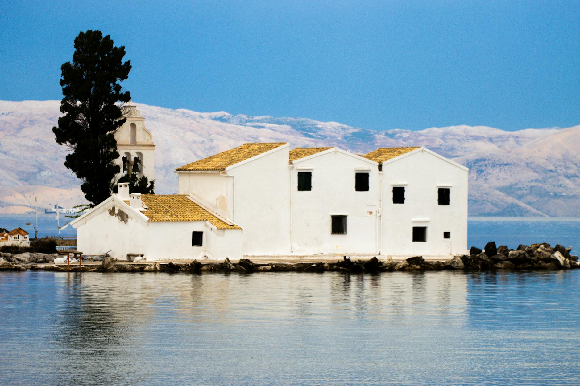 Picturesque Mediterranean harbor with traditional white buildings and blue waters
