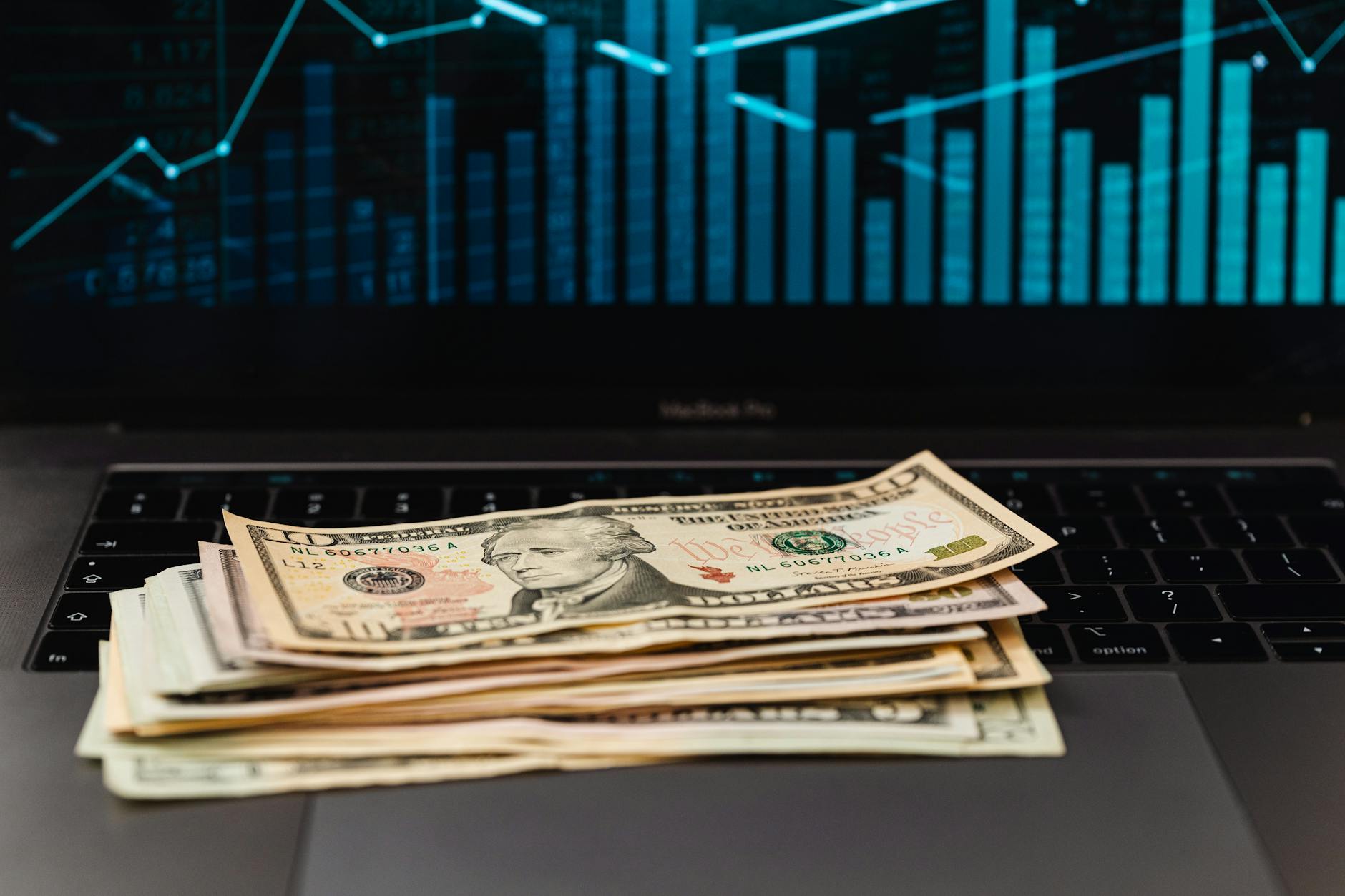 Financial newspapers and currency scattered on desk showing market analysis and economic data