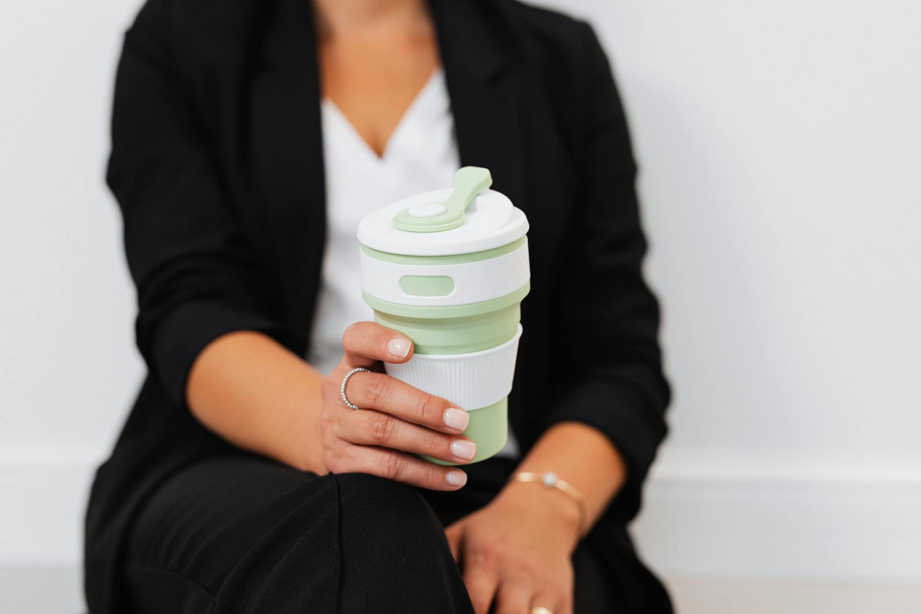 Eco-friendly reusable coffee cup on wooden table in cafe setting