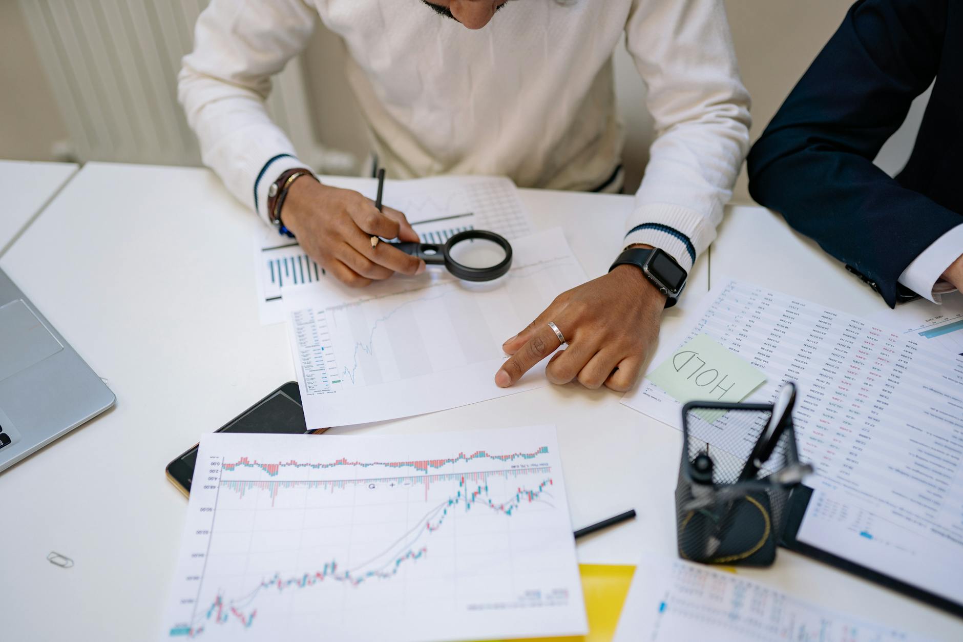 Business professionals discussing financial documents around conference table