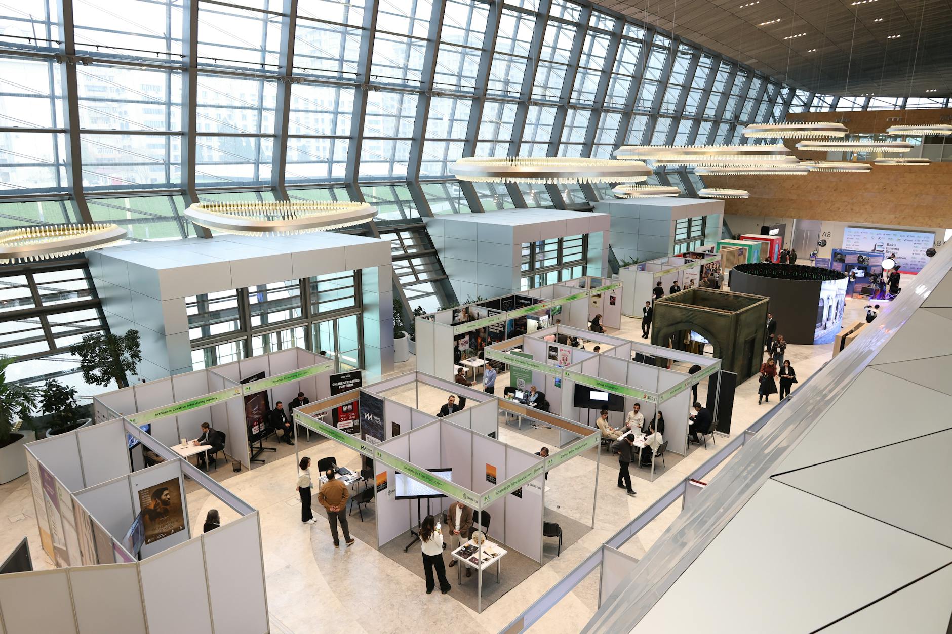 Busy financial trading floor with multiple screens displaying market data and price charts