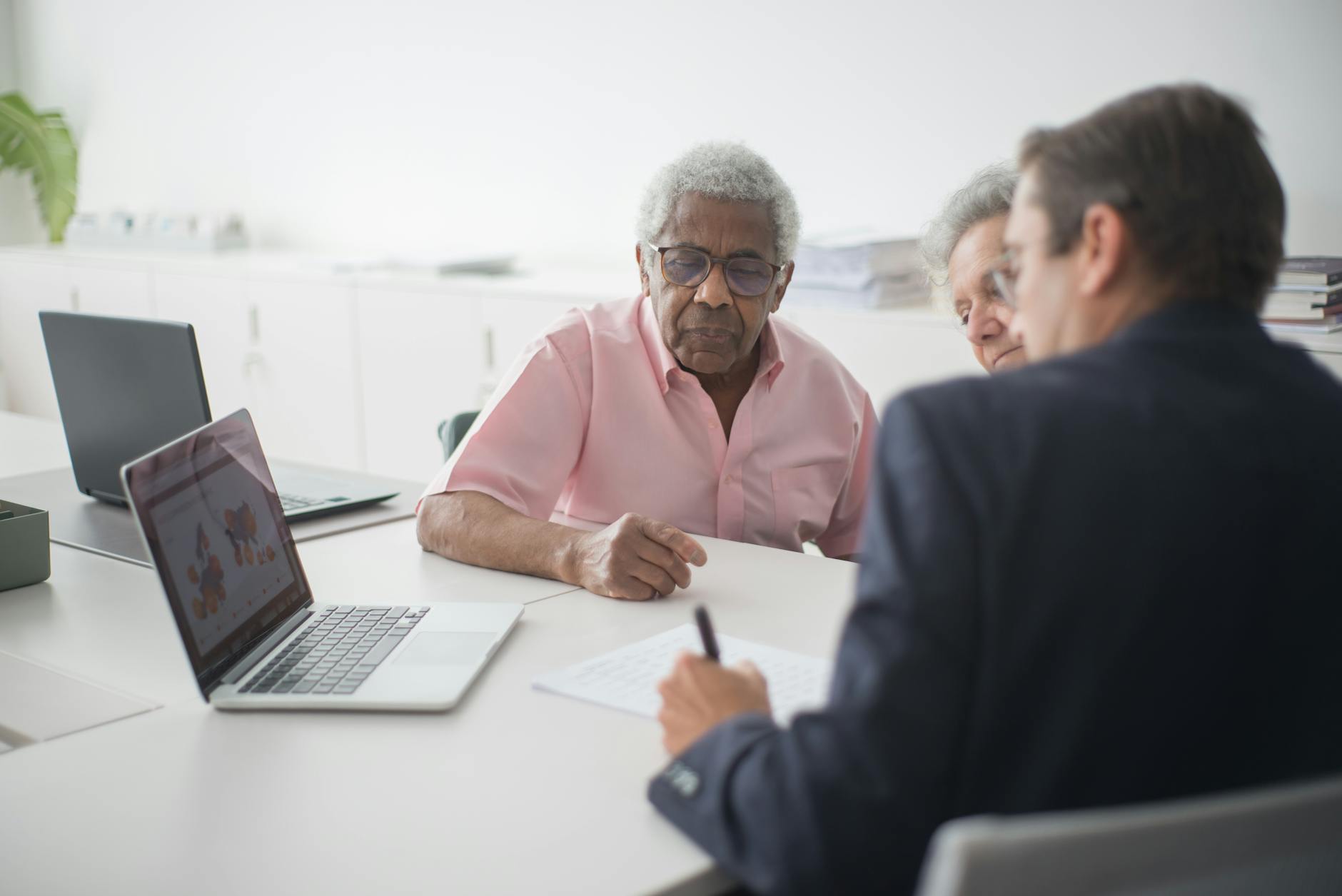 Senior adults reviewing financial documents and investment portfolios for retirement planning