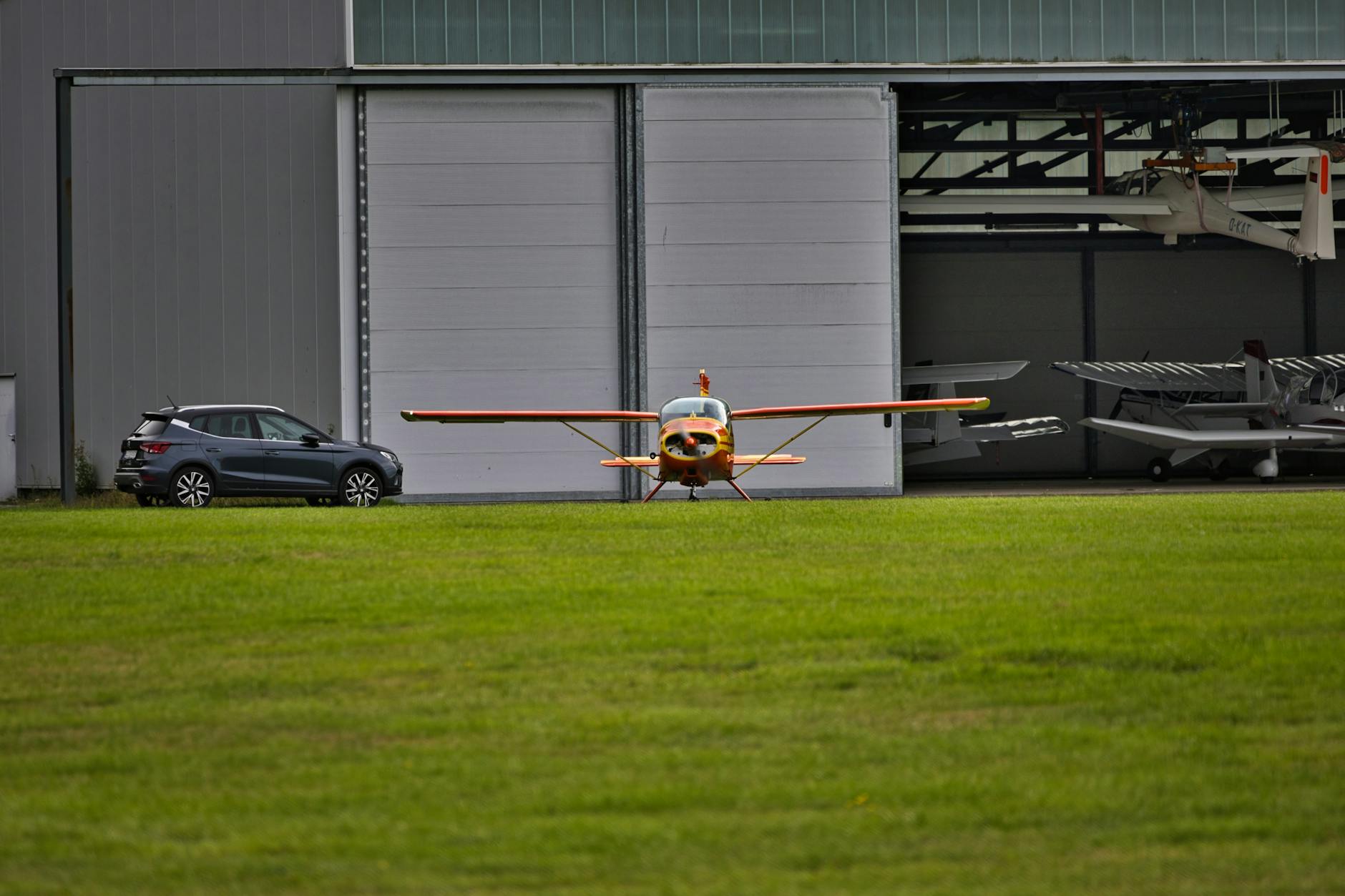 Large aircraft assembly hangar with planes under construction and industrial equipment