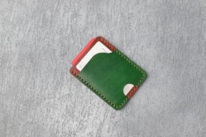 Major Credit Card Companies Eliminate Foreign Transaction Fees to Compete With Fintech Apps Multiple credit cards arranged in a leather wallet showing various card designs