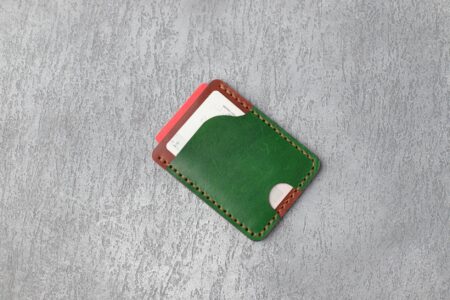 Major Credit Card Companies Eliminate Foreign Transaction Fees to Compete With Fintech Apps Multiple credit cards arranged in a leather wallet showing various card designs