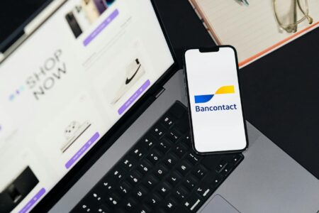 Major Grocery Chains Experiment With Mobile-Only Checkout Systems Person using smartphone to scan grocery items in store aisle