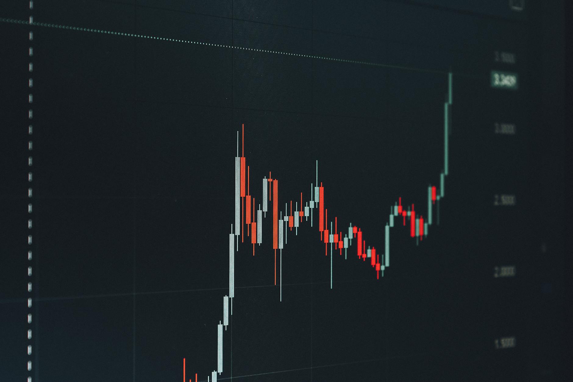 Trader monitoring bond market activity on multiple screens