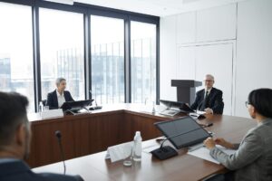 Major Consulting Firms Downsize as Companies Build Internal Strategy Teams Professional business meeting with executives discussing strategy around conference table