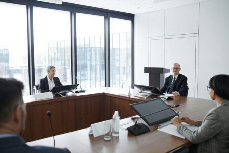 Major Consulting Firms Downsize as Companies Build Internal Strategy Teams Professional business meeting with executives discussing strategy around conference table