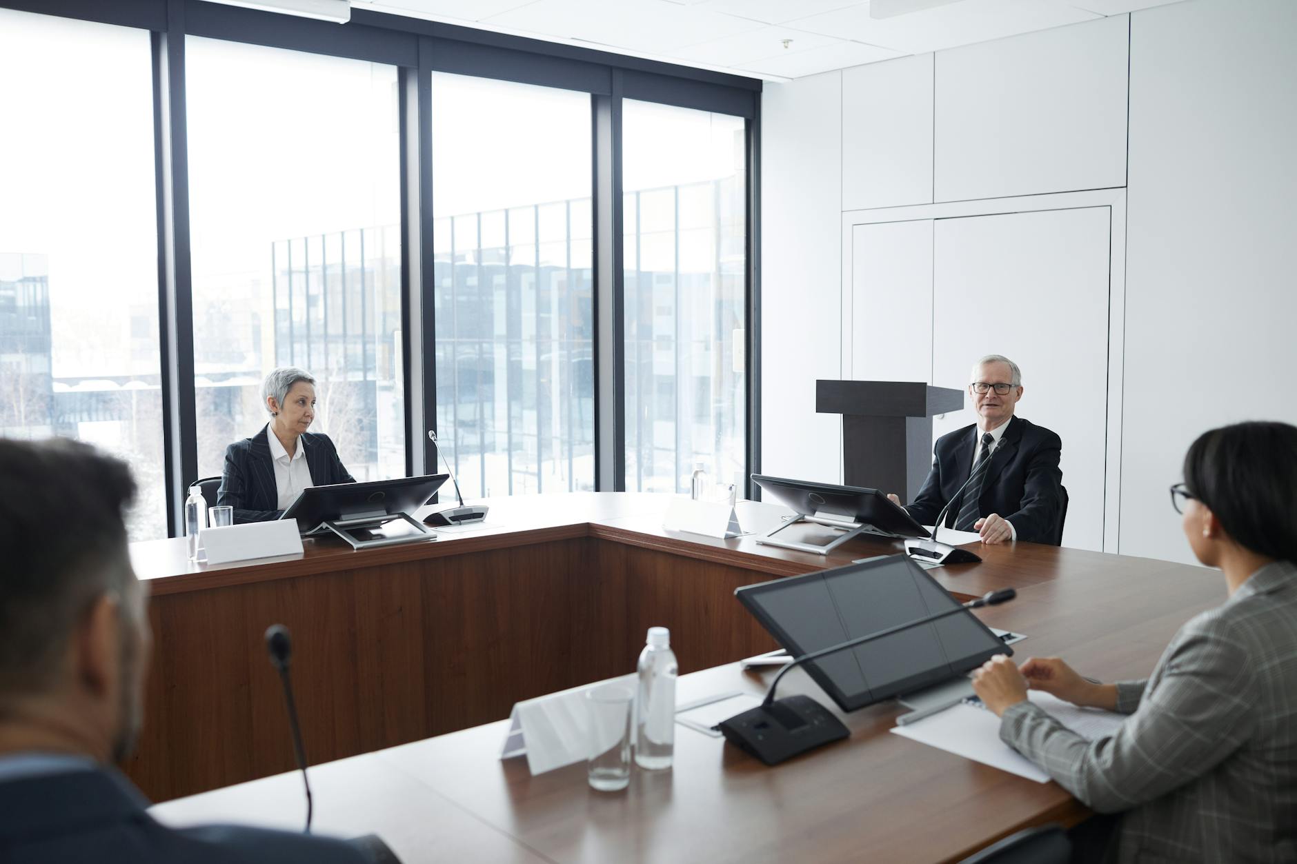 Professional business meeting with executives discussing strategy around conference table