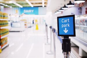 Grocery store aisle with shelves stocked with packaged consumer goods