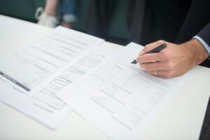 Insurance Companies Drop Coverage for Vacation Rental Properties Insurance policy documents and house keys on wooden desk representing property insurance coverage decisions