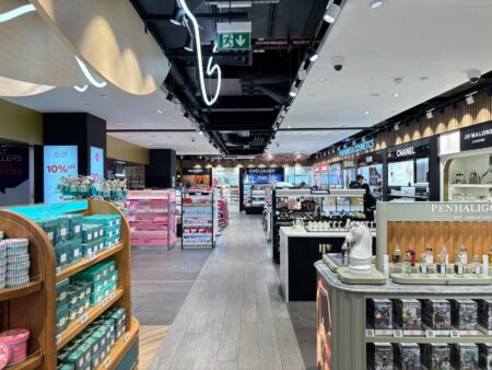 Major Department Stores Convert Beauty Counters to Mini Health Clinics Interior view of modern department store with open floor layout and service counters