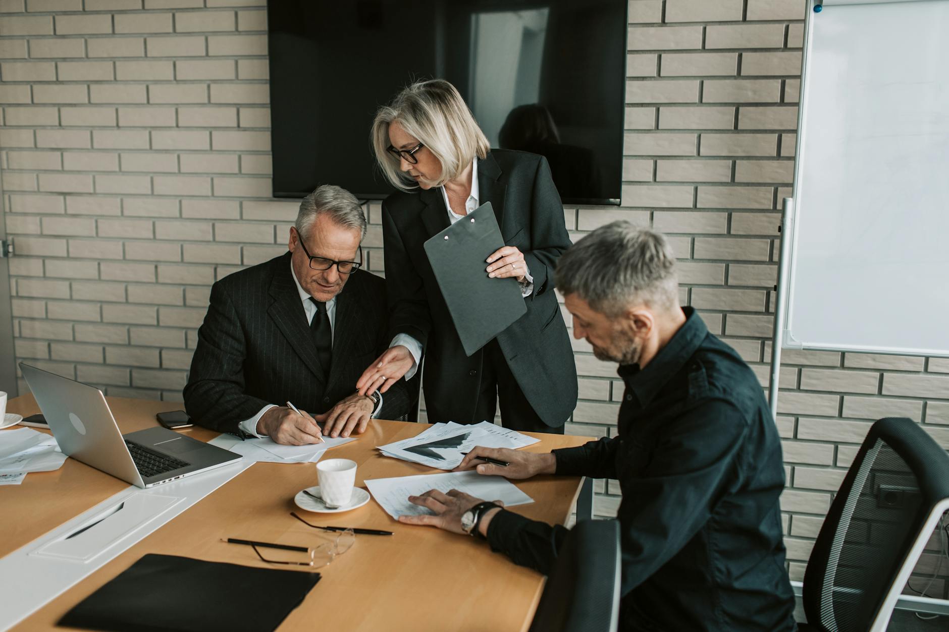 Investors in a boardroom discussing shareholder pressure and fund restructuring