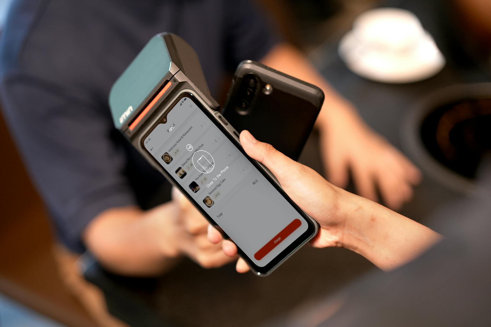 Close-up of hands using smartphone for mobile payment transaction