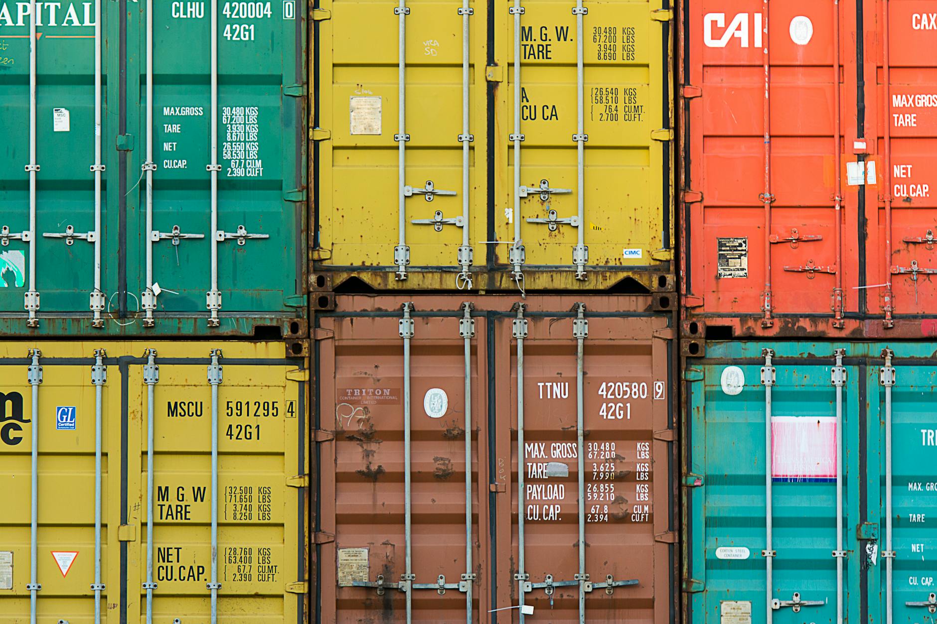 Cargo shipping containers stacked at a port representing international trade