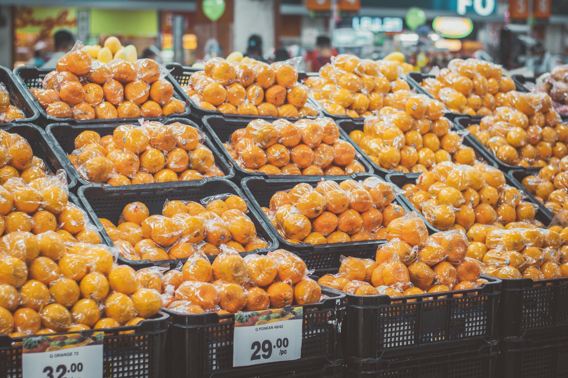 Consumer reviewing prices in a grocery store produce and dairy section