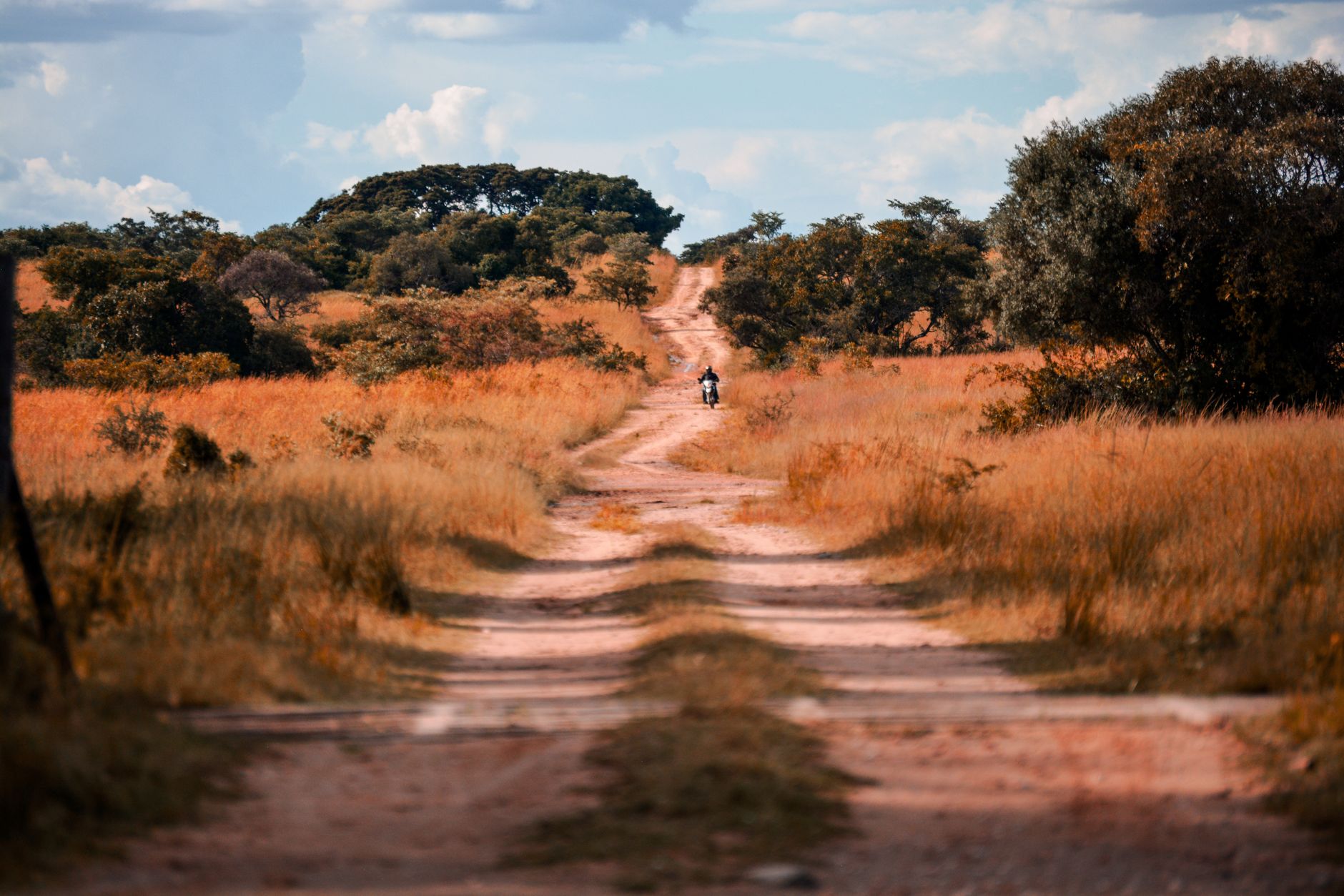 Long empty road through a remote rural landscape with no buildings visible