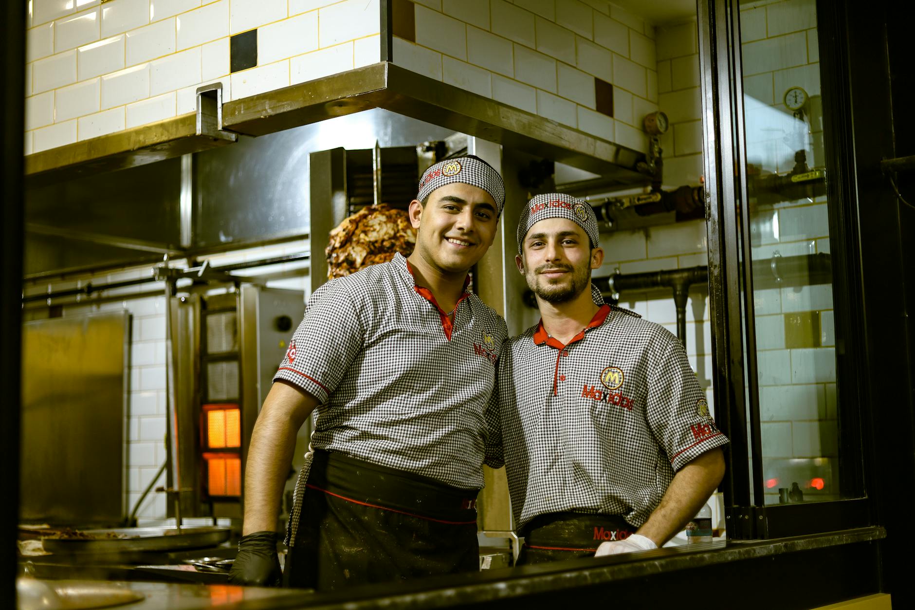 Fast food kitchen workers preparing orders during busy period