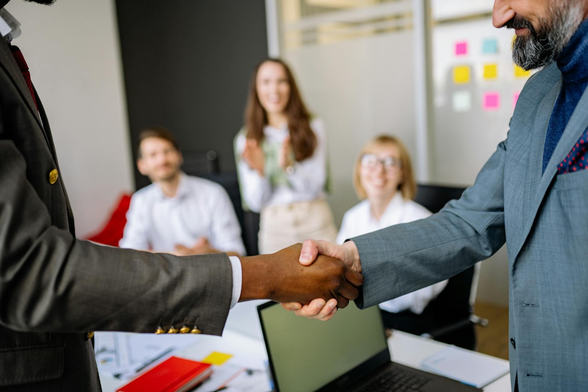 Professional handshake representing corporate acquisition deal