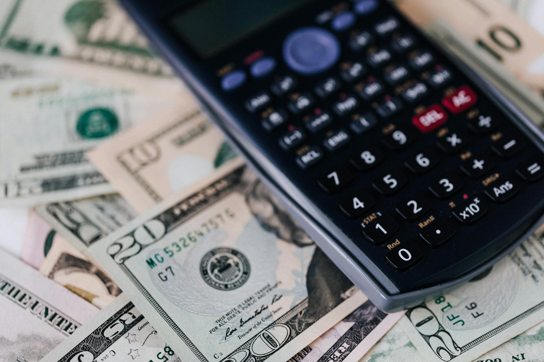 Calculator with cash and bills showing financial impact of rising insurance costs on property investments