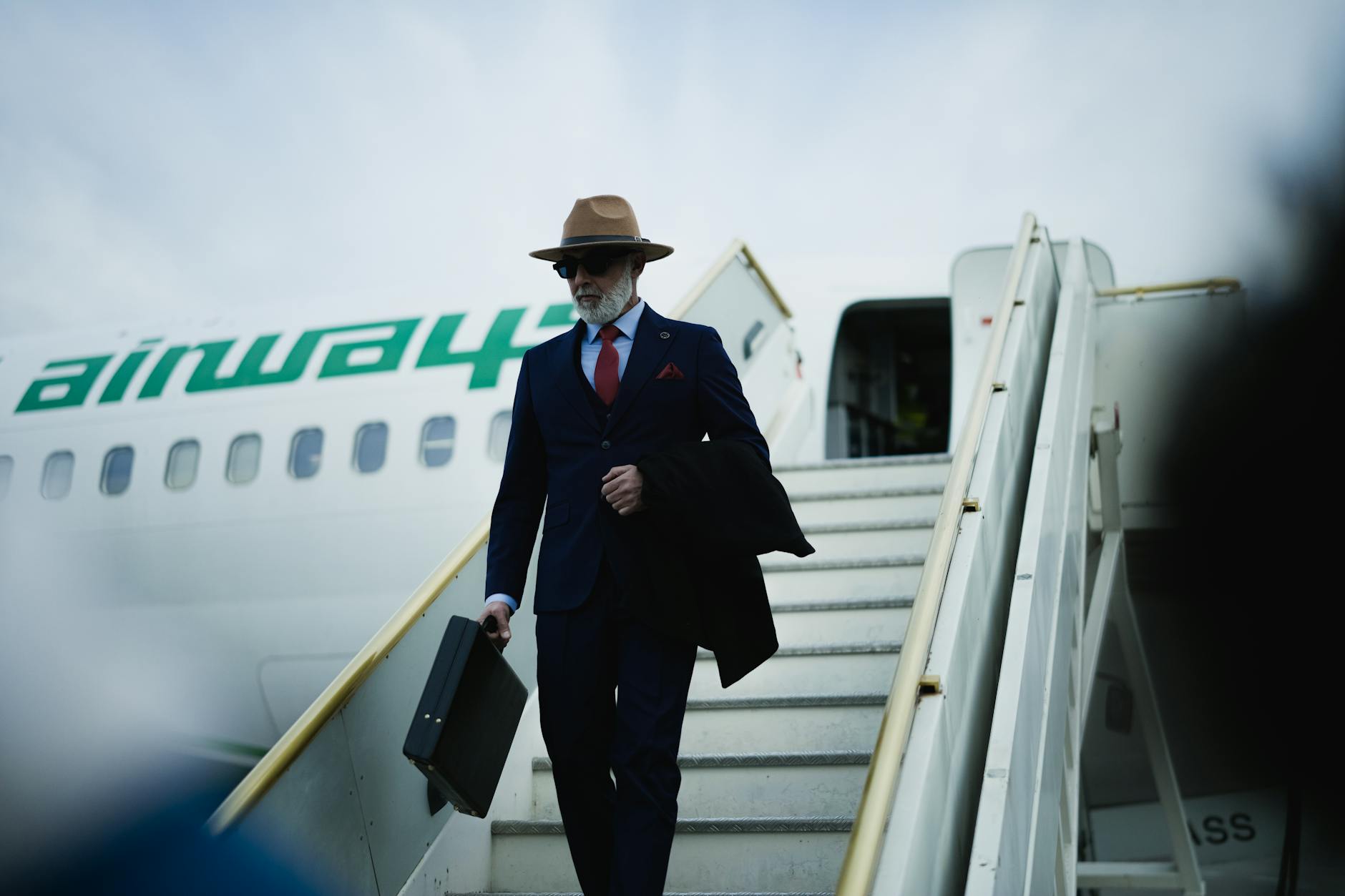 Professional business traveler using mobile device in hotel setting