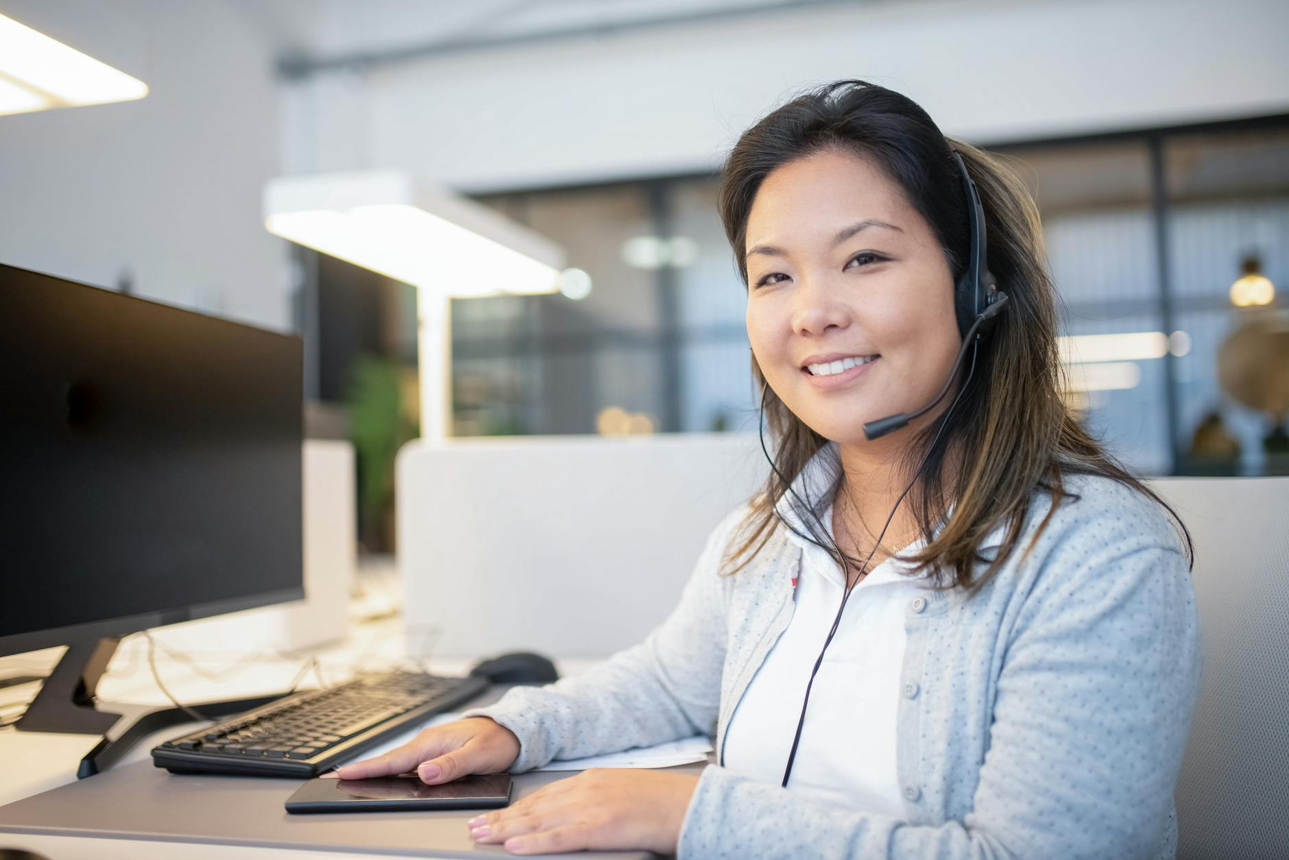 Professional bank employee assisting customer at service desk in modern banking environment