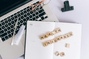 Medicaid Managed Care Insurers Brace for Enrollment Cliff Healthcare insurance professionals reviewing enrollment documents in an office setting
