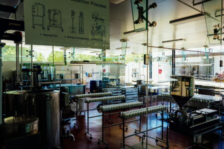 Workers operating machinery on a busy factory production floor