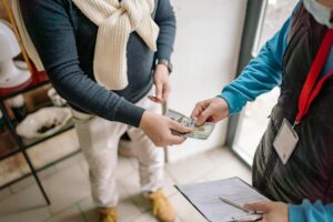 Person using a mobile phone to send a money transfer internationally