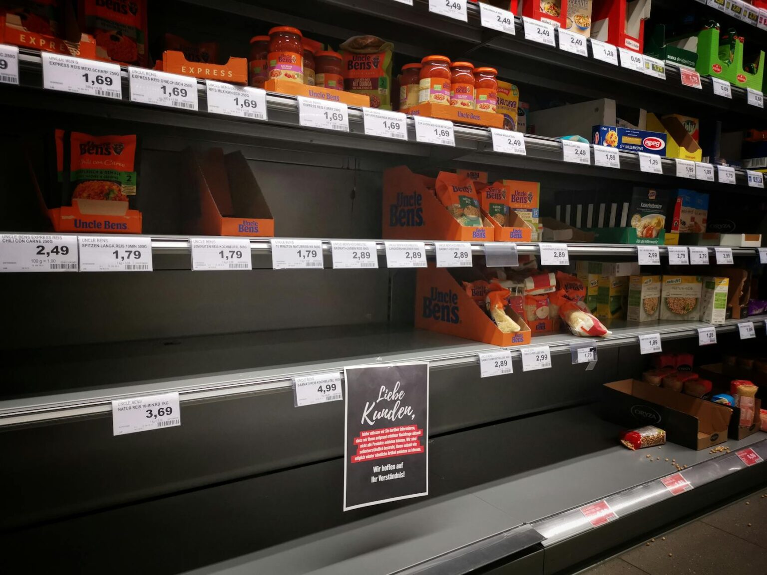 Empty shelves inside a closed grocery store in an urban neighborhood