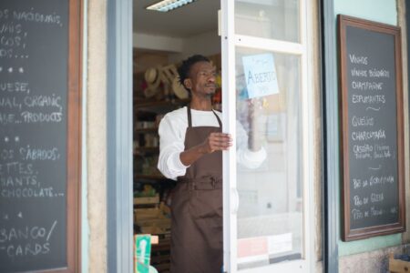 Small business owner reviewing financial documents at a counter