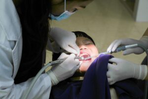 Medicaid Dental Benefit Cuts Leave Rural Seniors With Few Options An older adult sitting in a dental chair during a checkup, representing seniors relying on Medicaid dental coverage