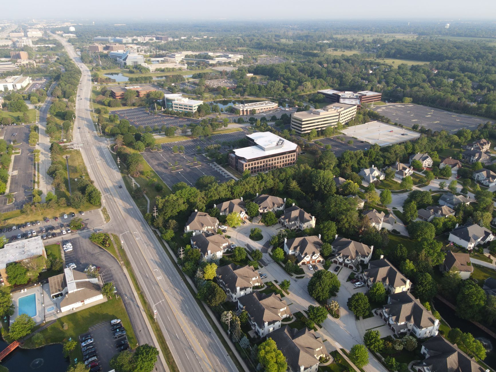 Empty suburban office park with large commercial buildings and quiet parking lot